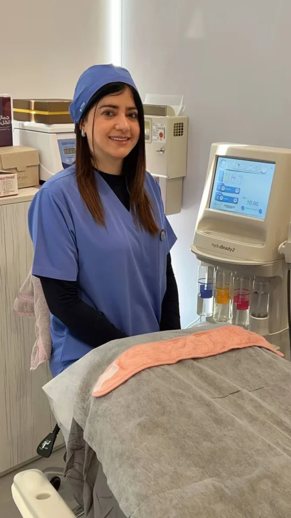 Facialist Maryam Siadat beside the HydraBeauty II device in the treatment room